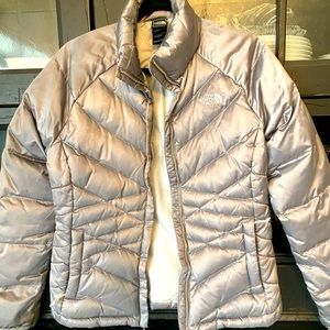 The North Face silver puff jacket, women's size Medium.